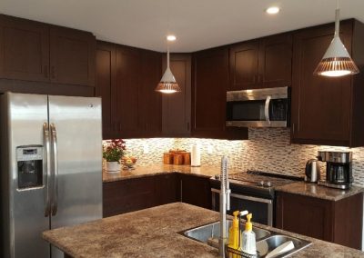 modern kitchen design with dark wooden cabinets and granite style counter tops