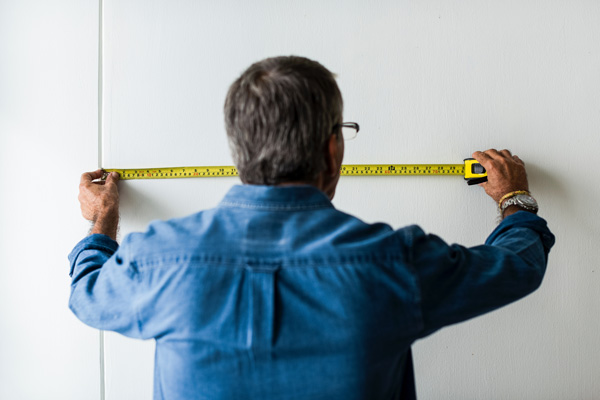 worker measuring wall